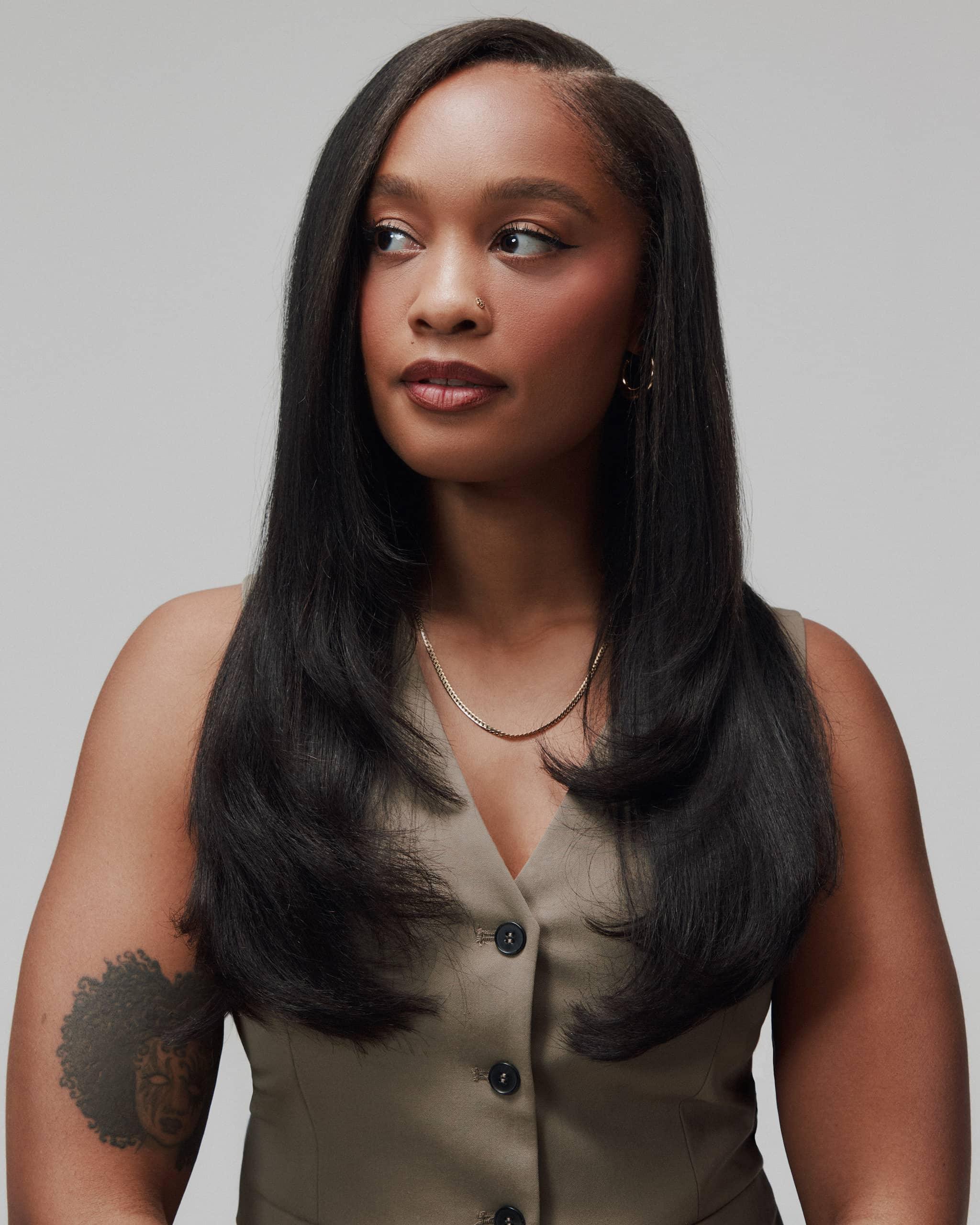 Front view of model wearing Fine Babe by SOWN. Raw Burmese human hair styled in a silk press finish that mimics Type 4 texture