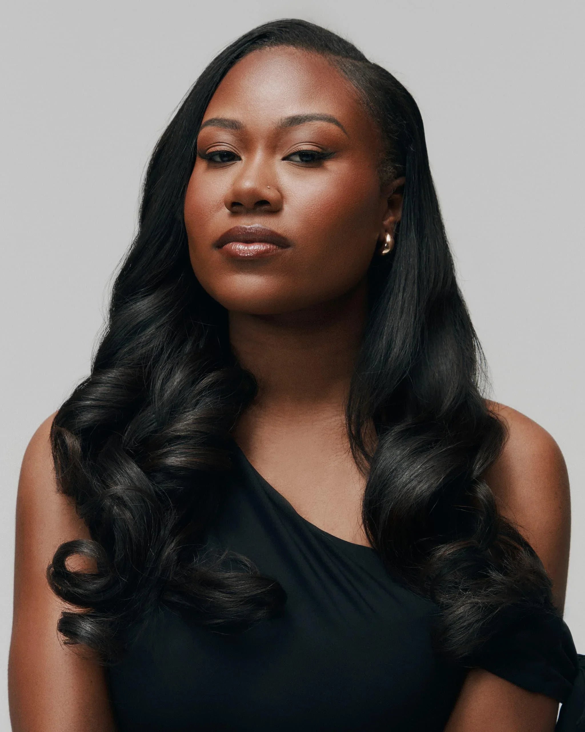 Front view of model wearing Trophy bundles by SOWN. Refined Vietnamese human hair styled in a silky, body wave finish that mimics Type 3 texture.